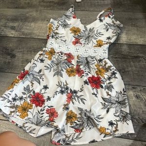 A M flower patterned multicolored Romper.